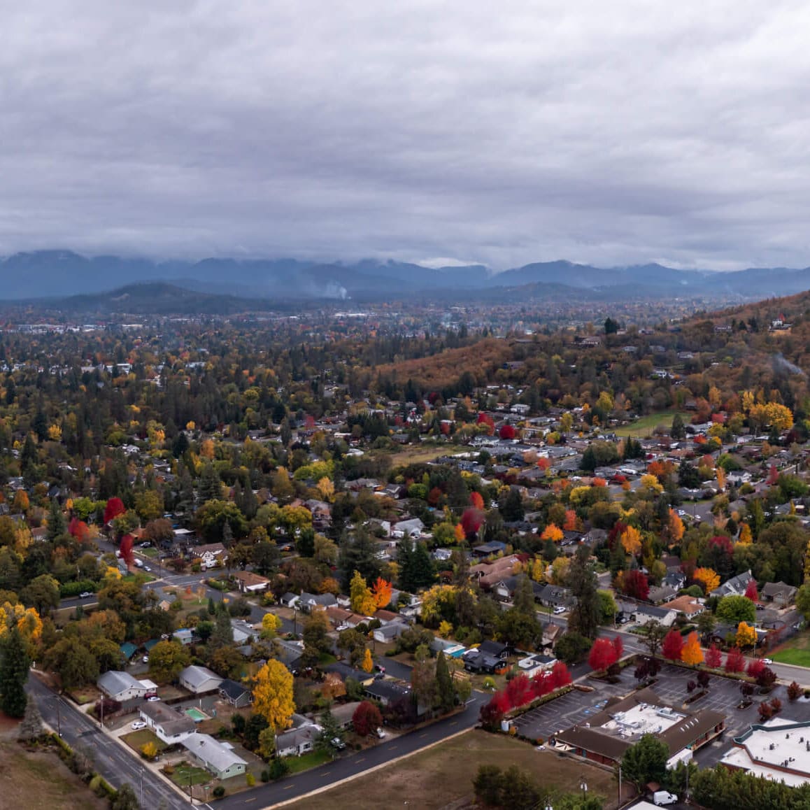 Aerial view of Grants Pass Oregon with trees in fall colors.